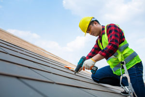 man repairs roof in Baltimore county
